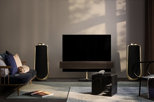 Bang & Olufsen television and speakers in a warm living-room interior